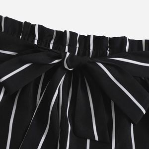 Pin striped black with white lines paper bag waist shorts.